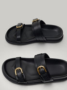 Urbain Couture black vegan leather slide sandals with double gold buckles and thick soles.