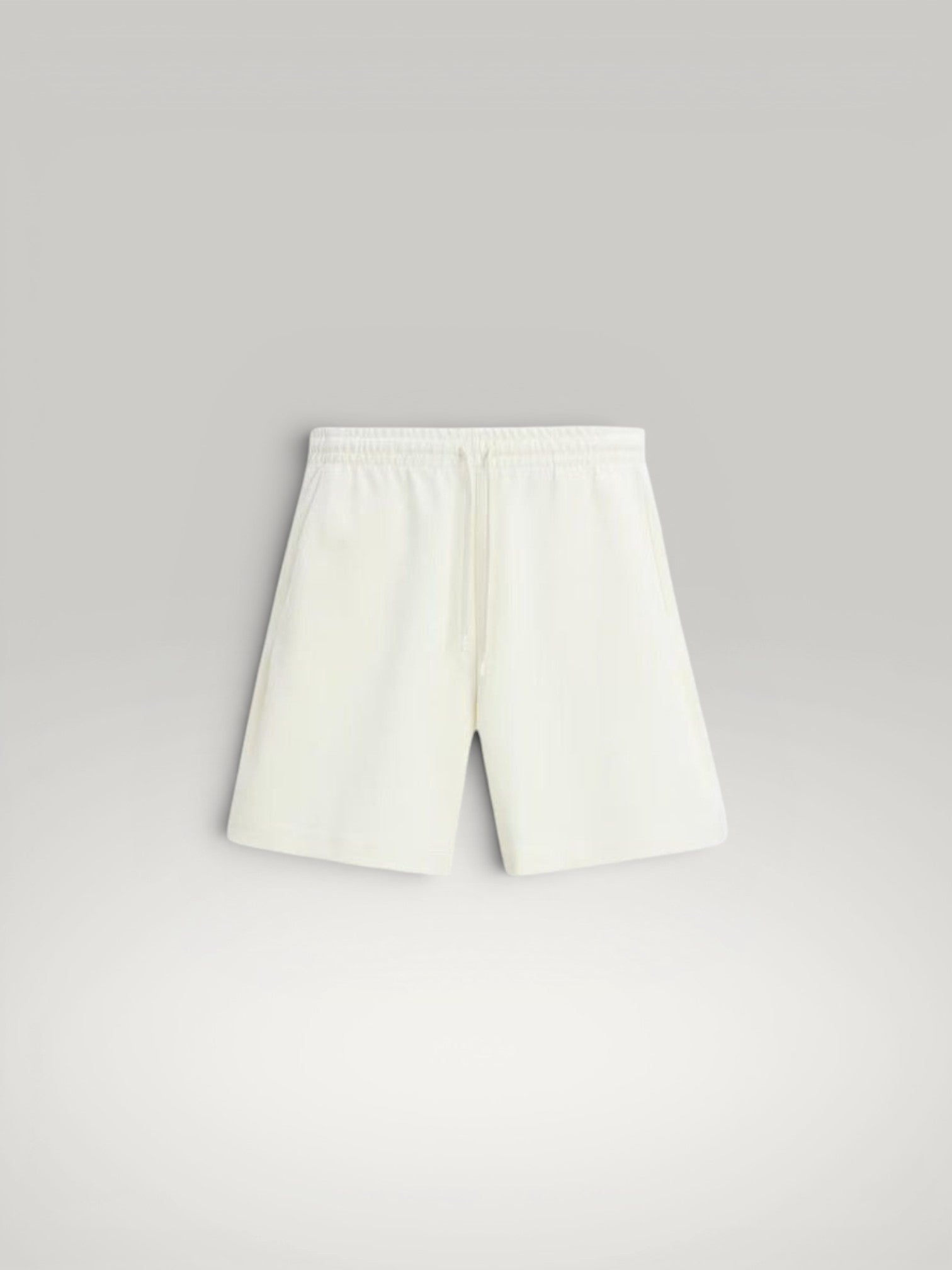 Urbain Couture cream textured oversized shorts with drawstring waist and side pockets.
